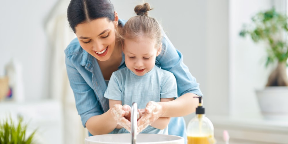 A mom builds healthy habits for kids
    by modeling hand-washing.